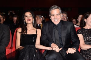 Pass the popcorn Mrs ClooneyGeorge Clooney and his wife, human rights lawyer Amal Clooney takes their seats in the auditorium