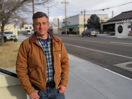 man poses near street