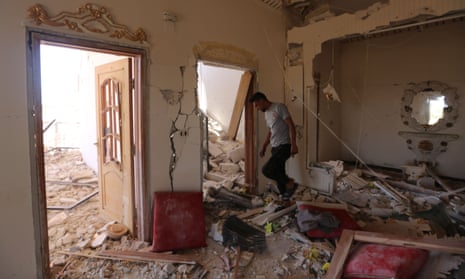 A Syrian man inspects his damaged home in the village of Balyun.