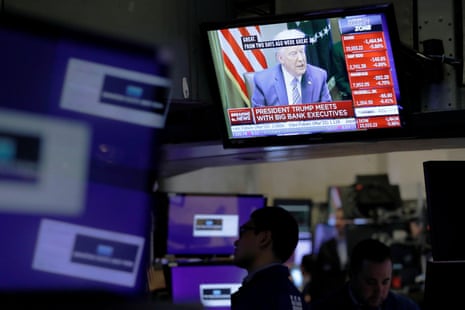 U.S. President Donald Trump is seen on a screen during his meeting with bank executives as traders work on the floor of the New York Stock Exchange (NYSE) in New York City, New York, U.S., March 11, 2020. REUTERS/Andrew Kelly