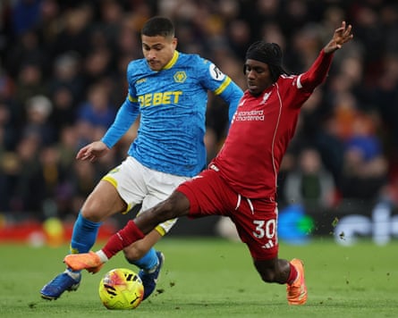 Liverpool’s Jeremie Frimpong tackles João Gomes of Wolves
