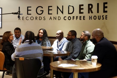 harris speaks at table surrounded by men