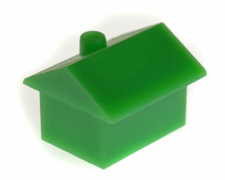 A green Monopoly game house-style counter