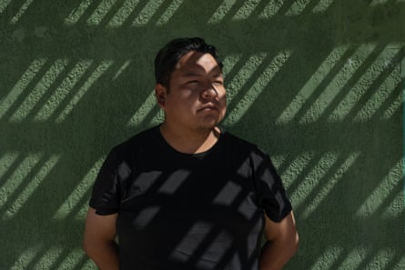 A man stands against a wall