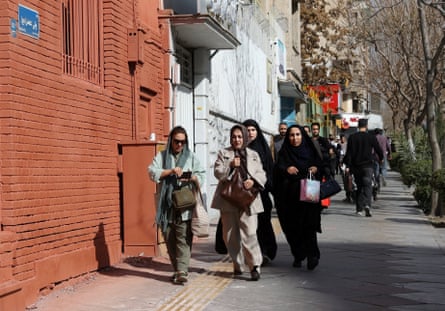 People run for cover along a city street