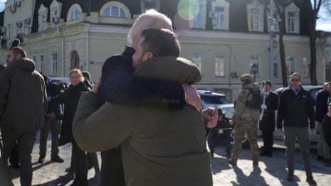 Biden and Zelenskiy hug in Kyiv after paying tribute to fallen soldiers – video