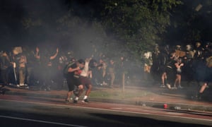 Protestors run as riot police fire teargas to clear Lafayette Park for Donald Trump to be able to walk through for a photo opportunity.