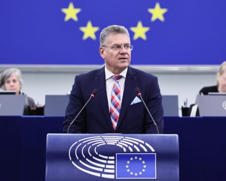 Maros Sefcovic speaks at a podium before an EU star backdrop in parliament