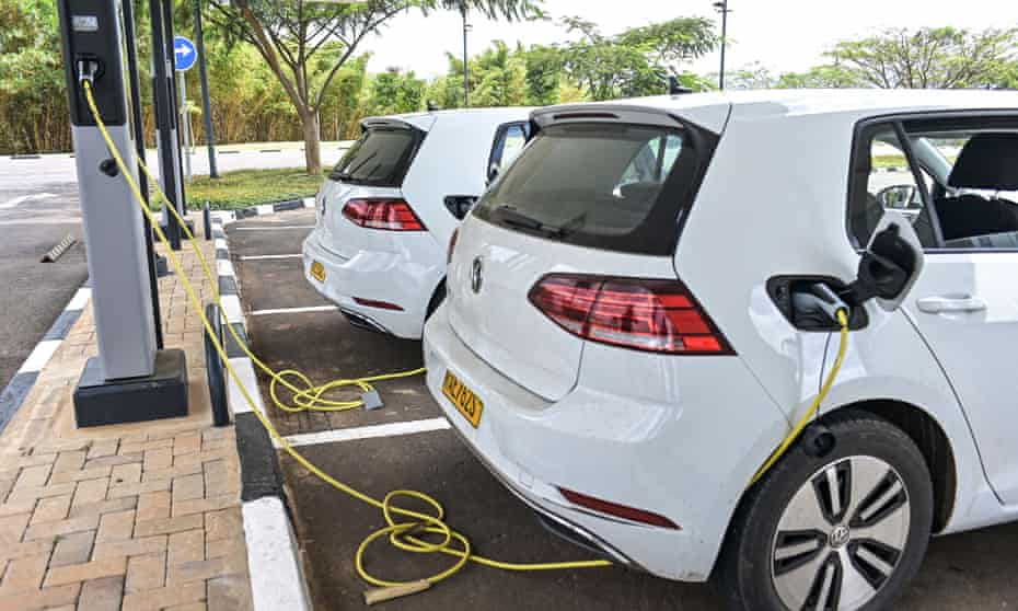 An electric VW Golf being charged in a car park