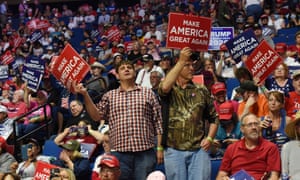 Supporters of Donald J Trump hold placards during a rally inside the Bank of Oklahoma Center in Tulsa, Oklahoma.