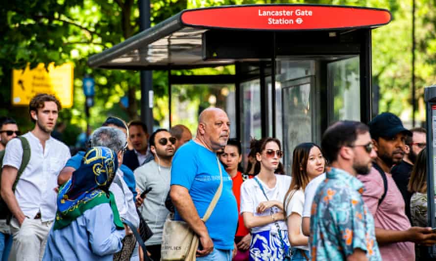 People waiting for a bus in central London.