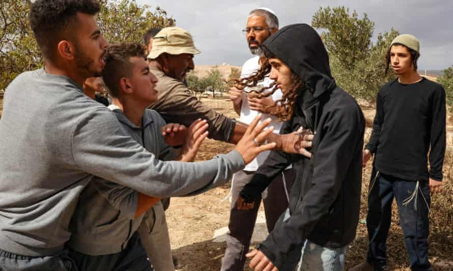 Palestinians scuffle with Jewish settlers, both from different parts of the village of Susiya