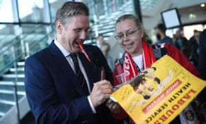 Labour’s Brexit secretary Keir Starmer signs a poster for a delegate