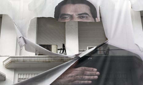 A torn banner depicting Zine al-Abidine Ben Ali photographed in January 2011. Tunisia’s autocratic ruler has died in exile in Saudi Arabia, aged 83.