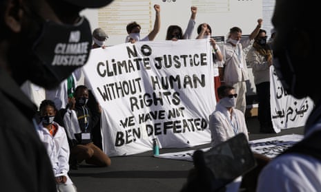 Demonstrators participate in a silent protest for climate justice and human rights at Cop27