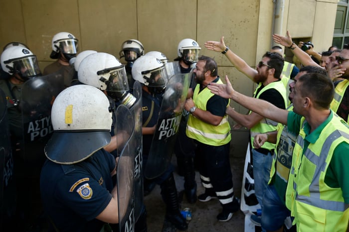 Miners from Eldorado gold mine in northern Greece argue with riot police today.
