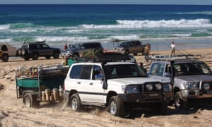 Tourists in four-wheel drive vehicles traverse Fraser Island