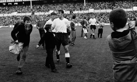 Jimmy Greaves (centre) is approached by young spectators following Tottenham Hotspur’s 6-2 victory over Manchester United in October 1962.