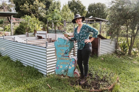 Nemeth standing by the community garden plantbeds
