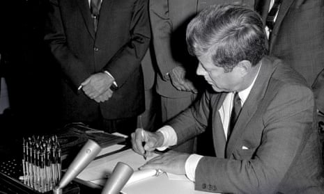 President John F Kennedy signs the Limited Test Ban Treaty in the White House.