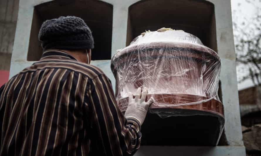 A victim of COVID-19 is laid to rest at a graveyard in Comas, on the northern outskirts of Lima. Peru on May 31 more than doubled its official coronavirus death toll, becoming the country with the highest coronavirus mortality per capita anywhere in the world.