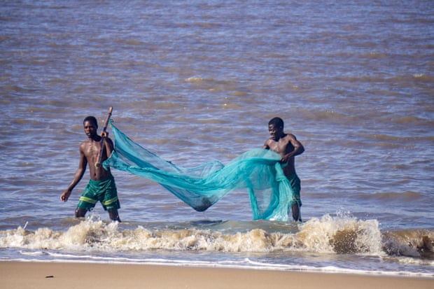 Jose Ferdinand and friend return from a fishing trip in Mozambique’s coastal city of Beira