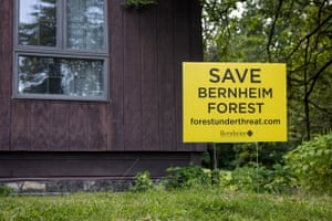 A yellow sign reads 'Save Bernheim Forest'