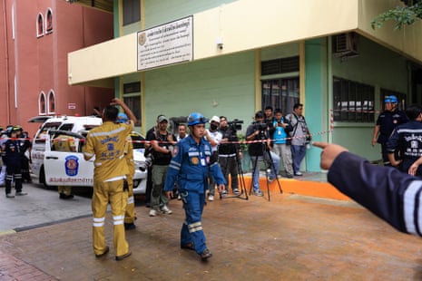 Members of the media and emergency personnel outside the school in the Nonthaburi province.
