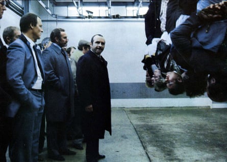 Moriarty standing behind Bob Hoskins (centre) in his distinctive grey suit and tie in The Long Good Friday, 1980.