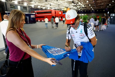 Kimi Antonelli signs an autograph on a shirt for a fan