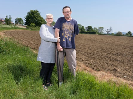 Anne and Mike Hartley, in front of their house overlooking the proposed site of a new housing devolopment in Marnhull, Dorset.