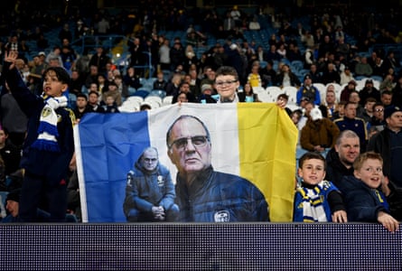 A Leeds fan holds a flag of Marcelo Bielsa