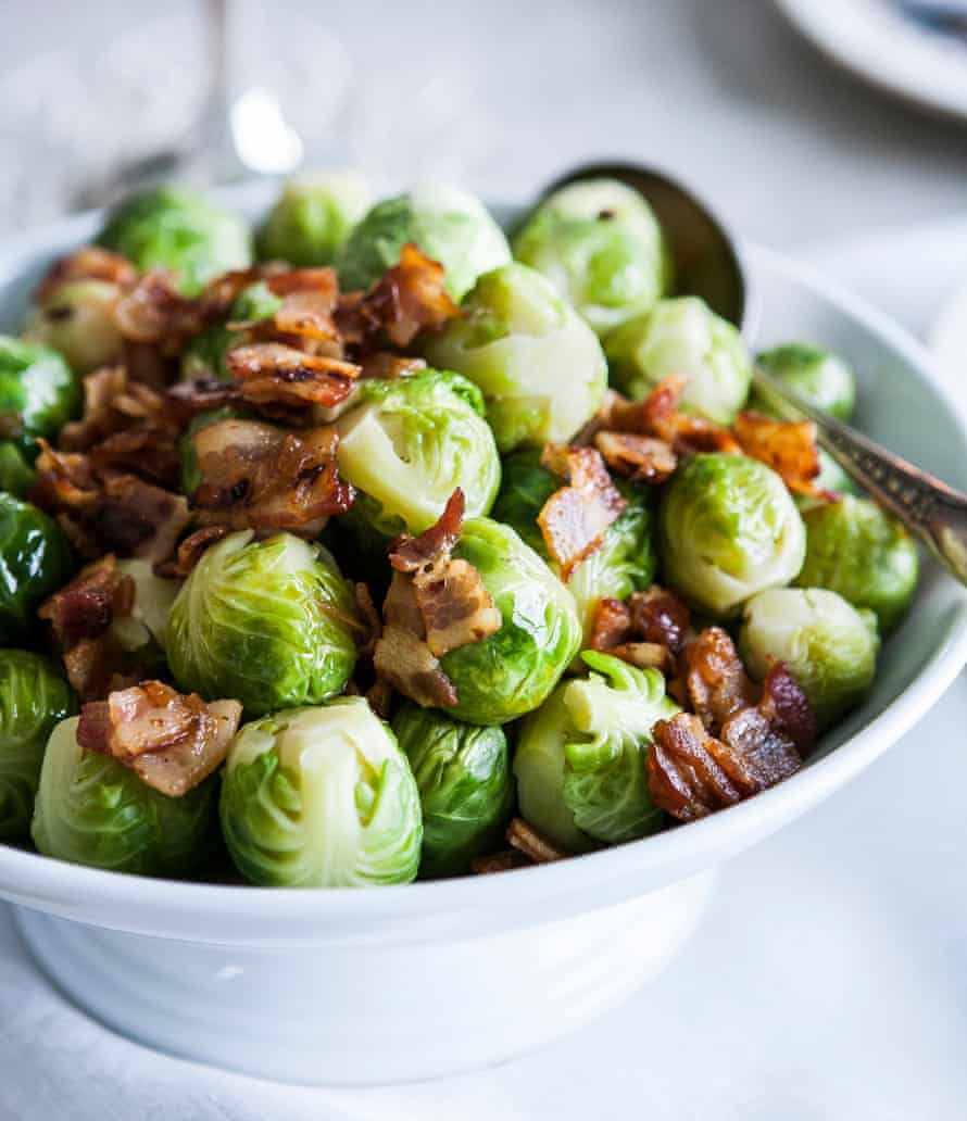 A bowl of brussels sprouts with fried spec.