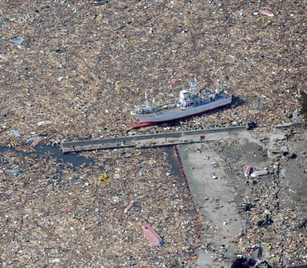 A fishing boat rests surrounded by debris in Kamaishi in the aftermath of the 2011 tsunami