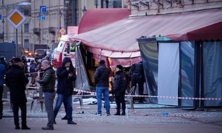 Russian investigators and police officers at the scene of the explosion in St Petersburg