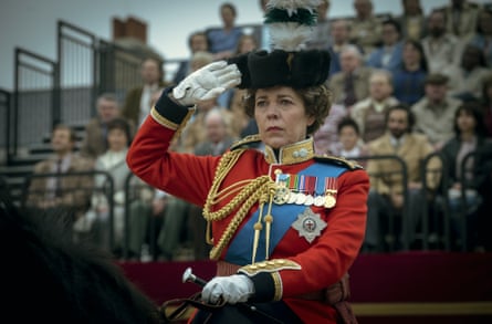 Olivia Colman as Queen Elizabeth II, in uniform, riding a horse, in a scene from The Crown