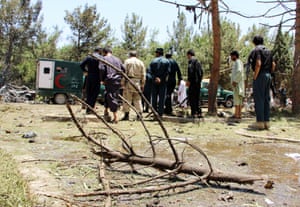 Afghan security officials examine the site of the blast.