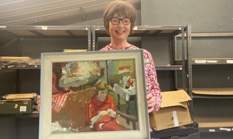Linda King, shipping manager at Ewbank's Auctions, Surrey, holding Portrait of a Girl, by Audrey Amiss