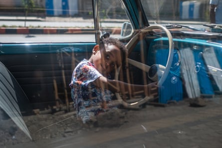 A child plays in a parked Beetle during a City Cruise meeting in Addis Ababa.