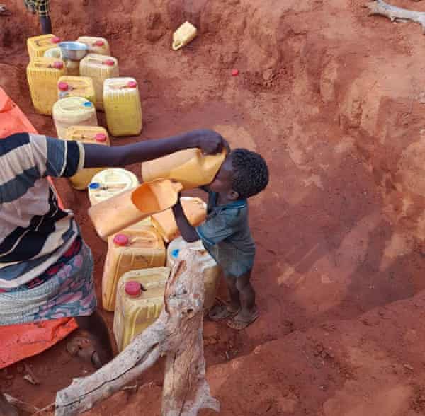 A child drinks water that has been brought into in an area controlled by al-Shabaab