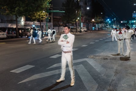 Jesus Méndez stands on the main avenue next to Plaza Garibaldi waiting to stop cars with other musicians, hoping to find a paying client. At times there are dozens of musicians here trying to stop passers-by from about 6pm until well past midnight.