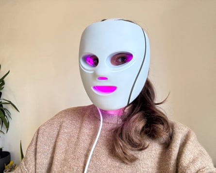 The writer wears a Shark Cryoglow LED mask
