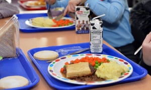 Picture of school meal - looks like cottage pie with carrots and peas - on a blue tray with young children, cropped so as not to reveal their faces. 3500.jpg?width=300&quality=85&auto=forma