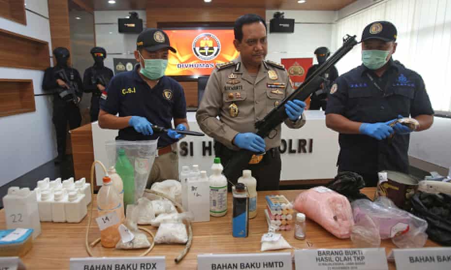 Police spokesman Rikwanto with weapons and bomb-making materials seized this week. 