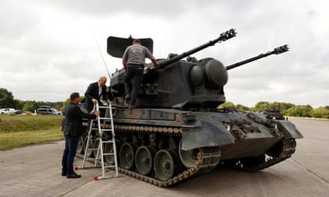 German Chancellor Olaf Scholz is shown an anti-aircraft gun tank Gepard, by Juergen Schoch the lead trainer for the Gebhard system, during his visit a training facility of the arms-maker Krauss-Maffei Wegmann at the Putlos military training area in Oldenburg in Holstein, Germany, 25 August 2022.