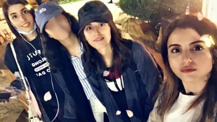 Four women, one whose face is blurred out.