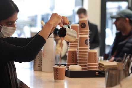 A woman pours hot chocolate into a cup at a Koops hot chocolate venue
