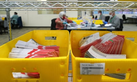 Boxes of vote-by-mail ballot envelopes await processing at the King county election headquarters in Renton, Washington.
