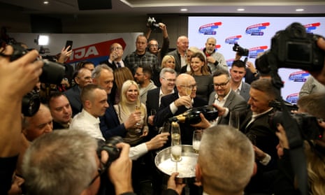 Serbian Progressive party (SNS) president Milos Vucevic (centre) celebrates with party members after the parliamentary and local elections in Belgrade