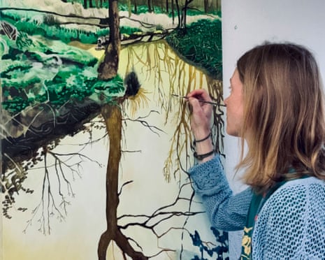 Howard with small paint brush working on a detail of a tree reflected on water
